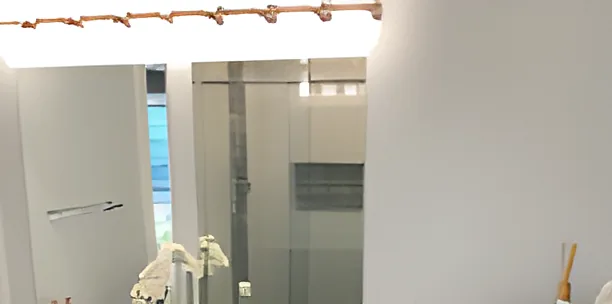 Black vanity with vessel sink and round mirror